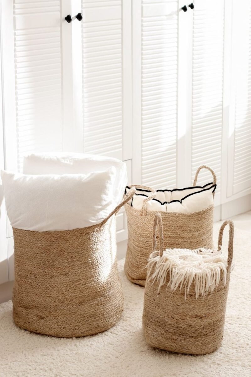 Matching jute baskets holding blankets and cushions for soft storage