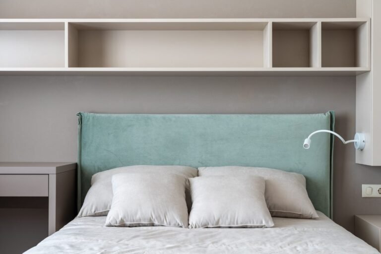 Small bedroom storage ideas with open shelves and cubbies above the bed