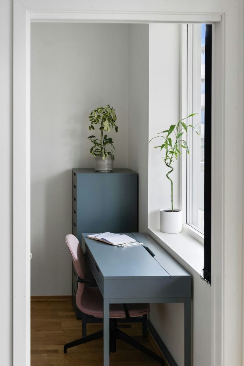 Compact study desk under a window in a small teen bedroom
