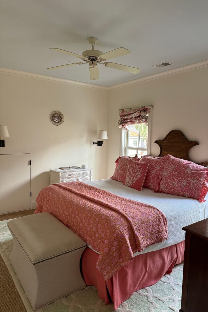 An upholstered storage ottoman at the foot of the bed