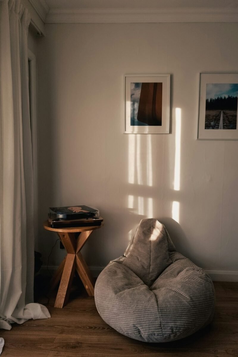Cozy corner with a bean bag chair and side table in a small teen bedroom