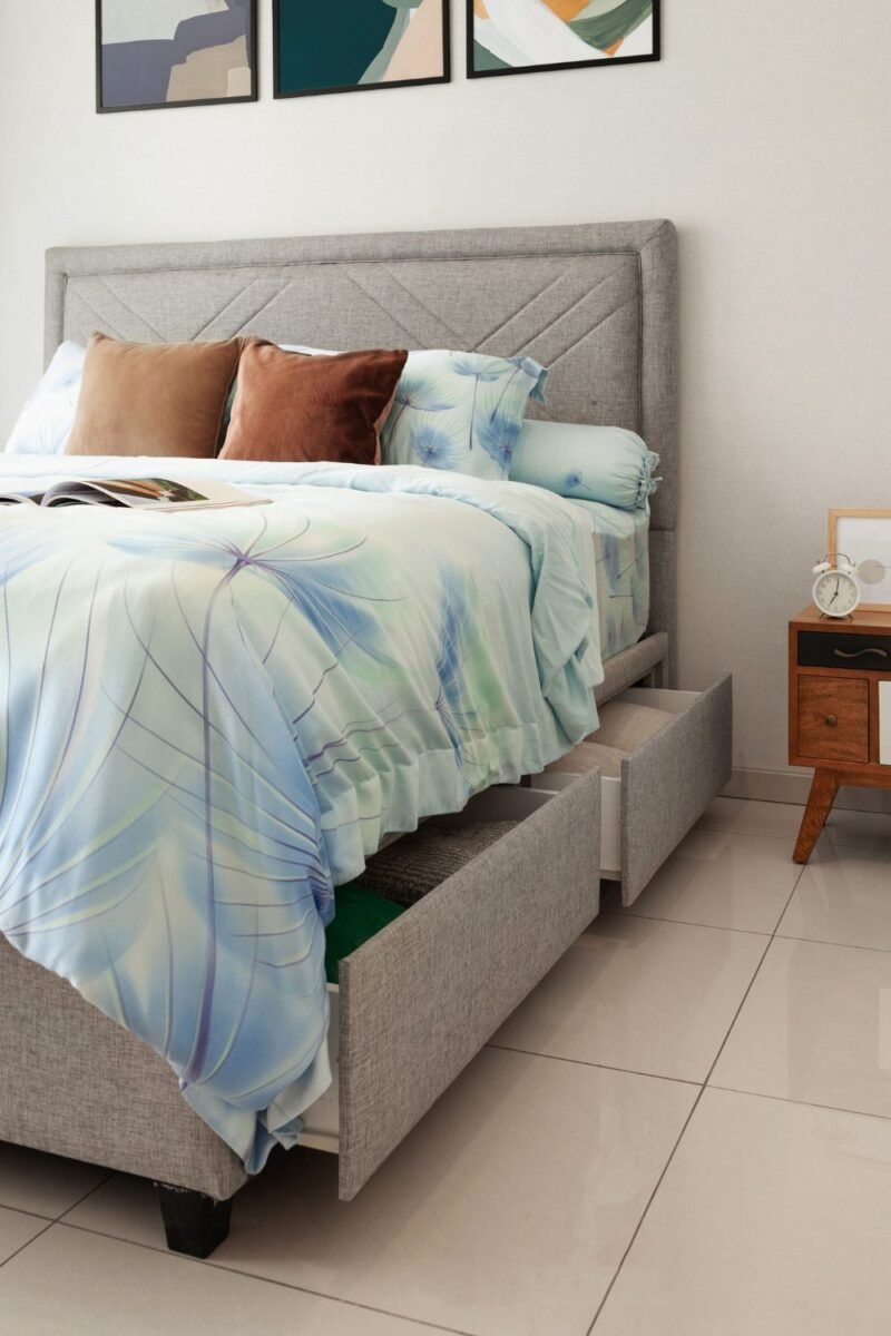 A bed with a built-in storage drawer pulled open under the mattress